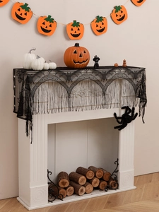 Detail of Halloween black lace fireplace scarf featuring bats and fringe tassels