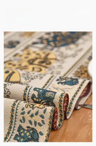 Close-up of elephant pattern table runner showing soft woven fabric texture on wood