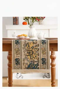 Detail of American ethnic style table runner with blue elephant patterns and fringe tassels