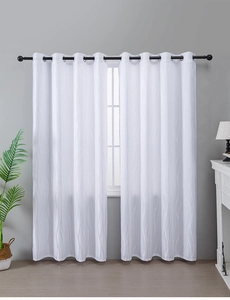 Detail of white semi-sheer curtain showing vertical wavy jacquard texture and metal eyelets