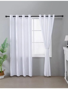 Close-up of white vertical stripe jacquard curtains with eyelet rings and soft textures