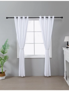 Detail of white vertical stripe jacquard sheer curtains with grommet top and pearl tiebacks