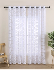 Detail of white French lace curtain featuring damask jacquard pattern and metal rings