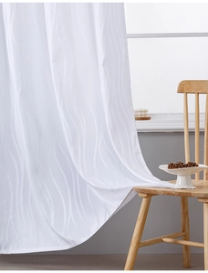 Detailed close-up of white semi-sheer curtains featuring vertical wavy jacquard texture