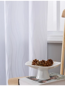 Detailed view of white curtains featuring wavy jacquard texture and elegant soft draping