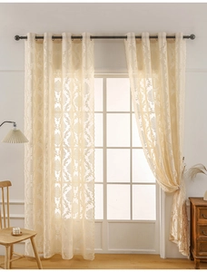 Close-up of beige French vintage lace curtain with damascus jacquard and wavy edges