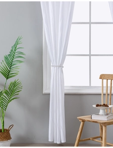 Detailed texture of white vertical stripe jacquard sheer curtain with crystal bead tieback