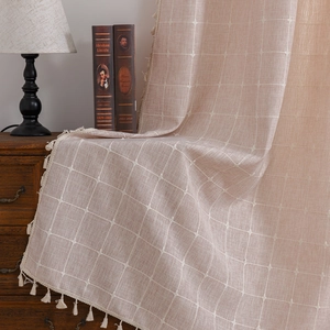 Minimalist beige plaid cotton linen curtains with tassel edges in a warm home setting