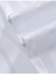 Macro detail of white vertical stripe jacquard fabric for sheer curtains with satin texture