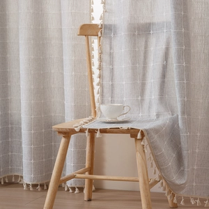 Modern light grey linen plaid curtain with elegant tassels for a minimalist living room