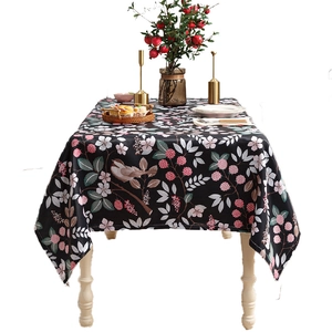American style floral tablecloth with birds and pink flowers on dark background
