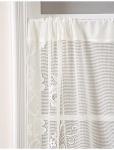 Detail showing delicate beige lace cafe curtain with intricate floral mesh embroidery pattern