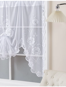 Close-up of white floral lace curtain featuring delicate scalloped edges and 3D floral texture