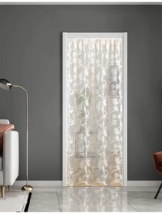 Detailed view of semi-transparent beige lace door curtain with tulip floral patterns