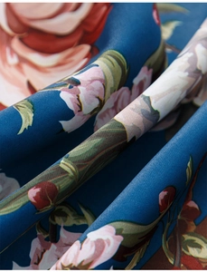 Close-up of thick blue luxury curtain fabric with elegant oil painting floral peony pattern