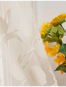 Close-up of beige tulip lace door curtain with intricate floral patterns and mesh texture
