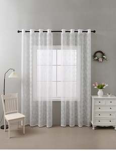 Detail of white lace curtains with branch patterns and black metal eyelets for a modern look
