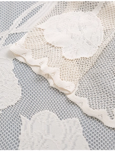 Close-up of beige tulip lace door curtain with detailed floral hollow-out embroidery