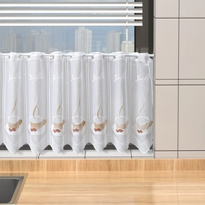 Detailed close-up of white lace kitchen curtain with coffee cup embroidery and Kaffee text
