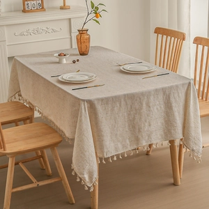 Minimalist linen tablecloth with fringe edges in a cozy modern home setting