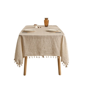 Minimalist linen rectangular tablecloth with tassel edges in natural beige color