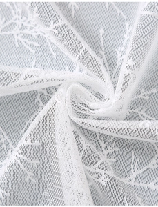 Macro shot of white sheer lace fabric with delicate branch patterns for curtains