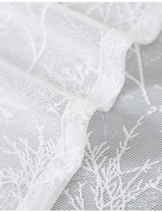 Detail of white lace fabric with branch jacquard patterns for curtains and home decor