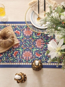 Detailed view of dark blue floral table runner with intricate peony patterns and white borders