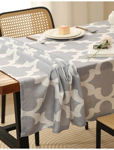 Macro detail of grey geometric clover pattern and thick woven texture on polyester tablecloth