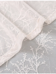Detailed macro view of white branch pattern lace fabric for curtains and home decor