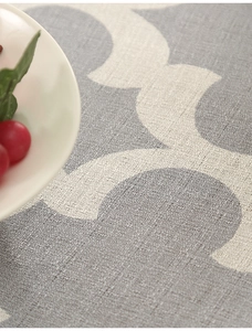 Close-up of grey geometric print tablecloth showing thick polyester fabric texture
