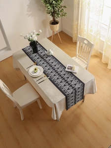 Detailed top view of a minimalist black table runner with white geometric patterns