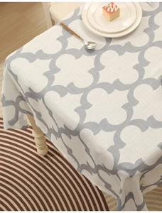Close-up of thick polyester tablecloth featuring grey clover patterns and fabric texture