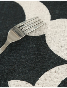 Macro detail of thick polyester tablecloth with blue geometric floral patterns and texture