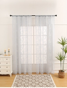 Close-up of light blue lace curtains with rose floral patterns and rod pocket design