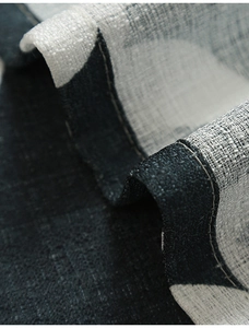 Macro shot of high-end paisley print fabric with detailed double-stitched hem and texture