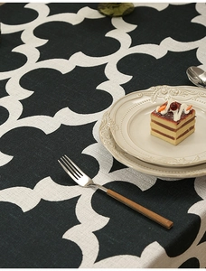 Detail of black Moroccan clover patterned tablecloth with premium woven texture on a table