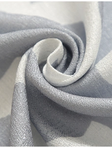 Dettaglio ravvicinato di tessuto in lino grigio e bianco con motivi geometrici e pieghe