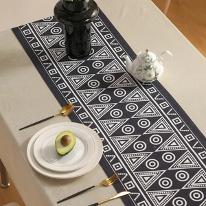 Modern black geometric table runner with waterproof fabric in a stylish dining setup