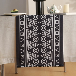 Modern minimalist black table runner with white geometric pixel patterns and cotton-linen texture