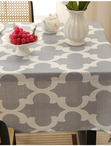 Detailed close-up of grey Moroccan geometric print tablecloth with a natural draped texture