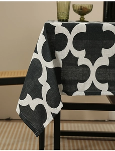 Close-up of thick polyester tablecloth featuring black and white geometric flower patterns