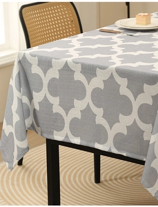 Detail of grey clover pattern tablecloth showing thick fabric texture and elegant drape
