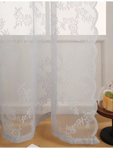 Detailed view of white rose lace curtain with scalloped edges for modern French decor