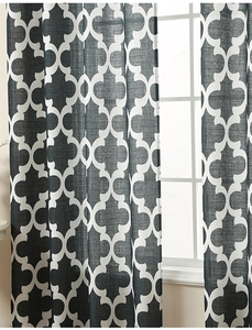 Detailed macro view of dark grey quatrefoil patterned curtain with textured linen fabric