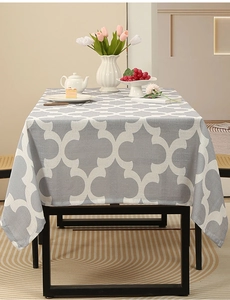 Close-up of grey Moroccan quatrefoil printed tablecloth on a dining table setup