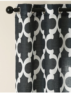 Detail of grey Moroccan tile print curtain fabric with silver metal grommets
