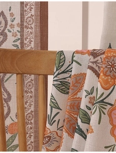 Close-up of linen fabric with botanical patterns on a minimalist wooden cabinet