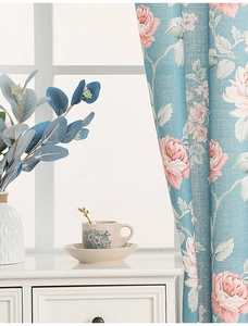 Detail of floral printed curtains featuring pink roses on teal linen texture fabric