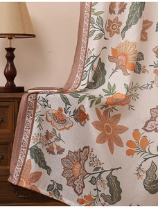 Detailed texture of retro floral curtain with woven fabric and decorative brown wavy edges